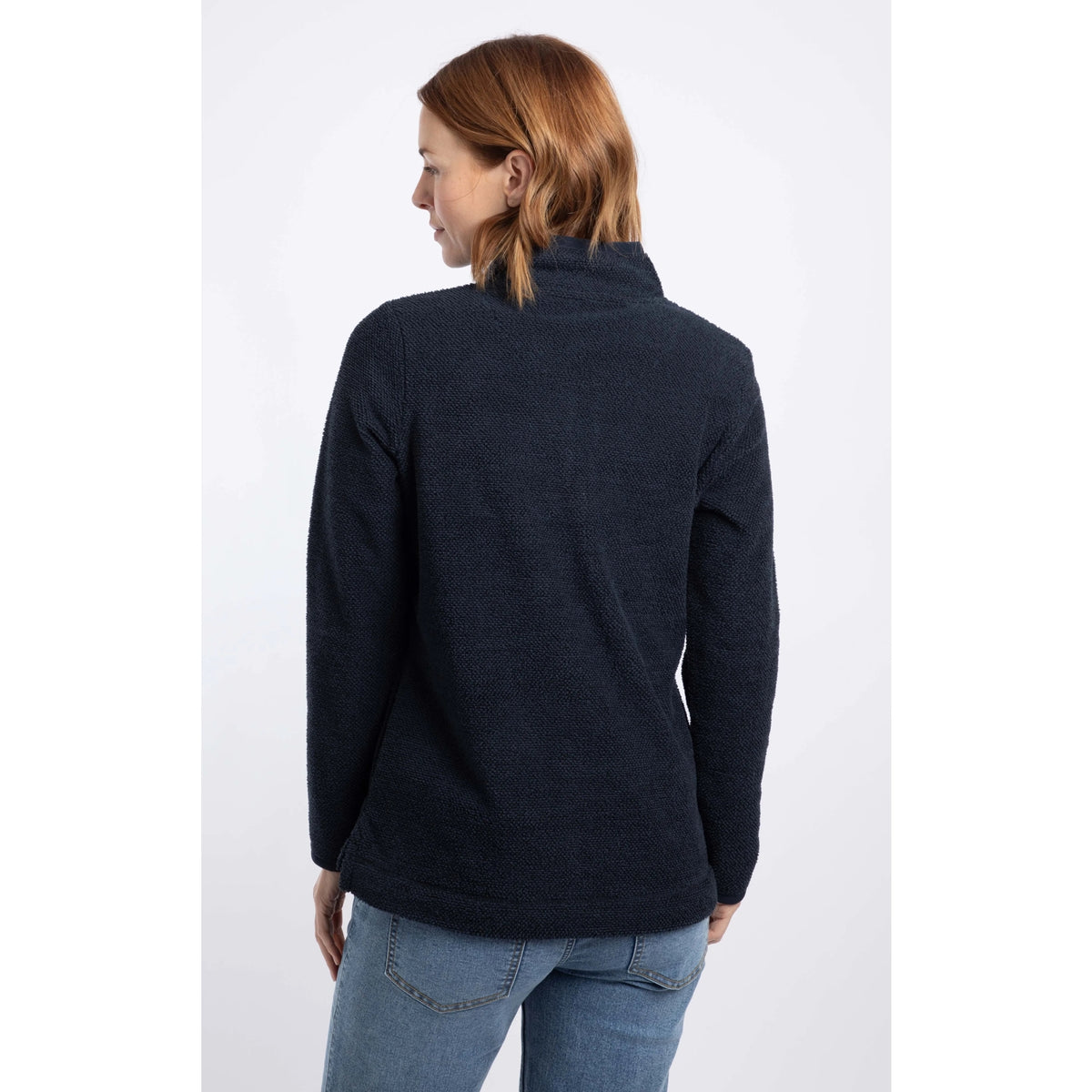 Back view of a woman wearing a Weird Fish 1/4 zip Sarah fleece in Midnight Navy