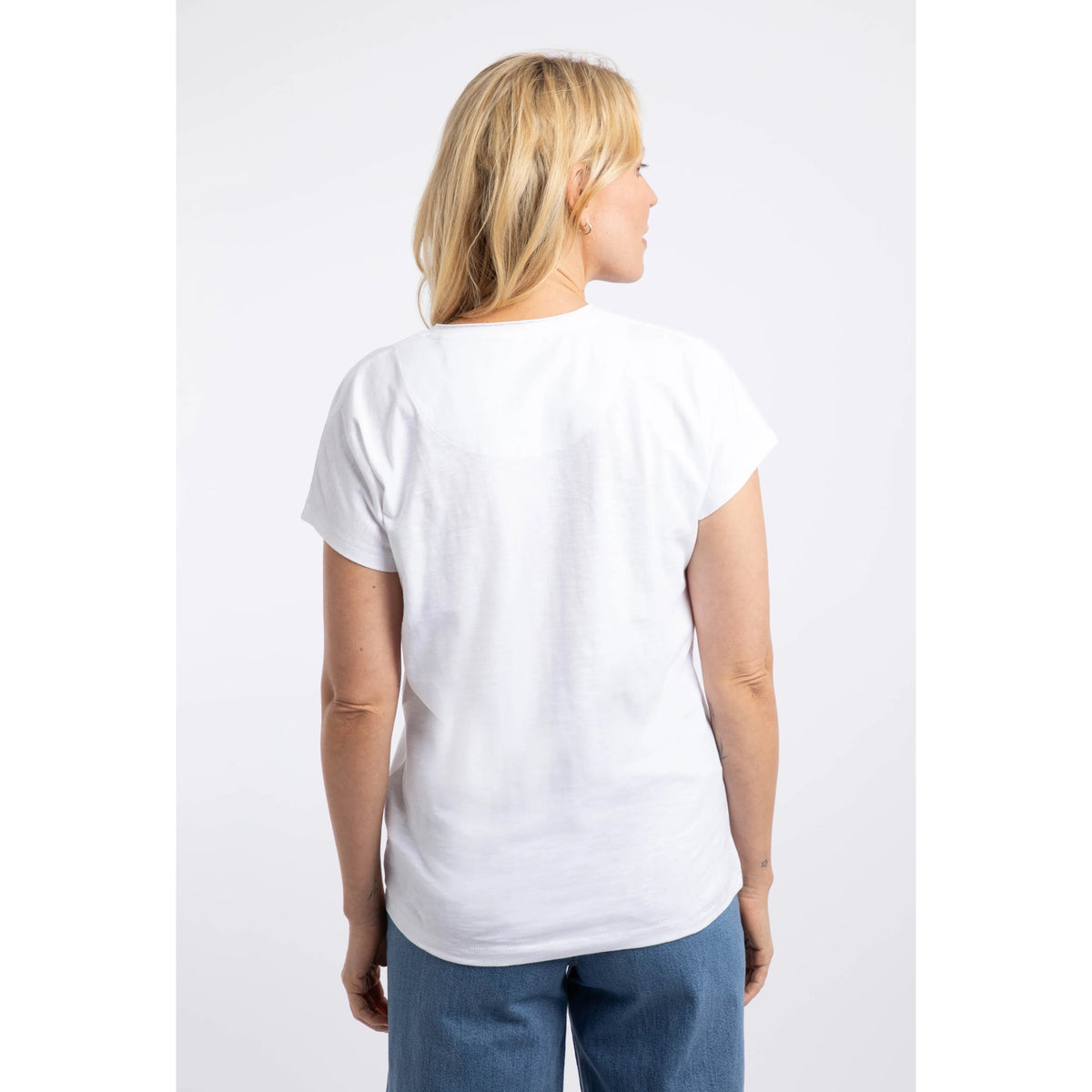 Back view of a woman wearing a Weird Fish short sleeve Take the Lead t-shirt in white with five dogs printed across the chest.