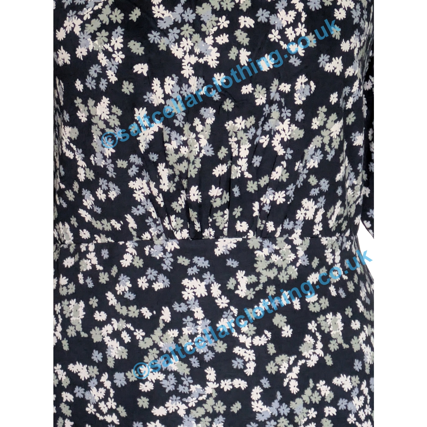 Close up of the gathered fabric waist of a Weird Fish Cassandra Ink Navy ditsy floral pattern dress