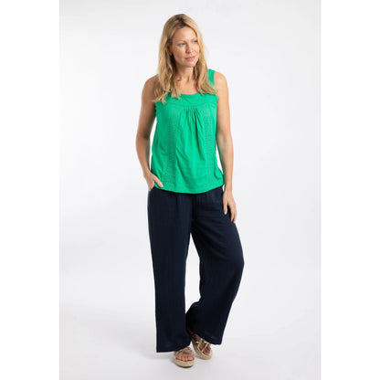 Woman wearing a Weird Fish Chelle square neck vest in Gumdrop Green with navy trousers.