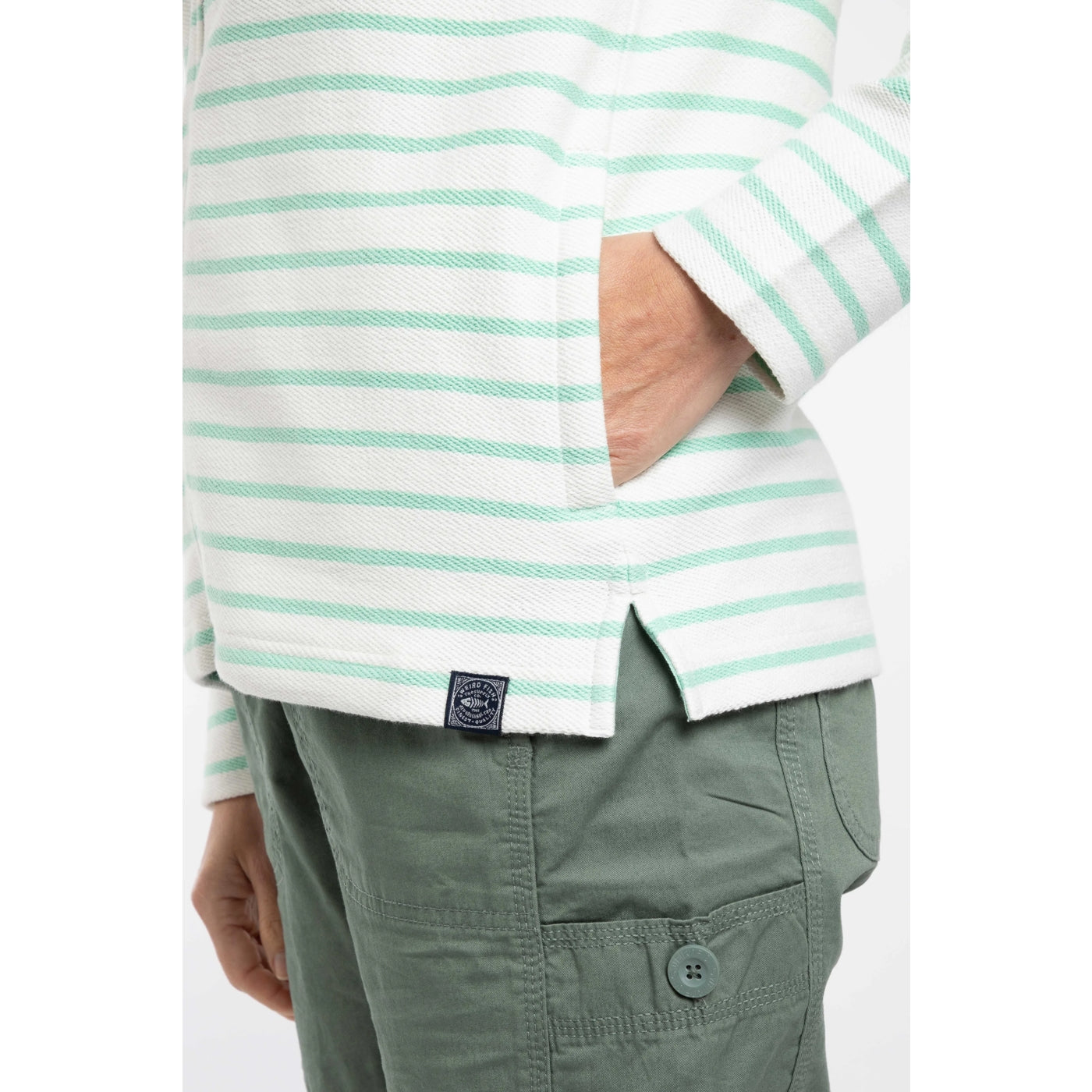 Close-up view of the side pocket and logo patch of a women's Weird Fish Catalina full zip loopback hoodie in an Apple Mint green and white stripe pattern
