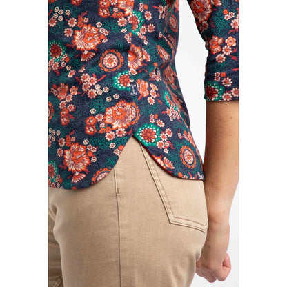 Floral patterned three quarter sleeve t-shirt with a person wearing beige pants on a white background