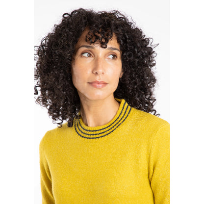 Woman wearing a yellow Weird Fish jumper with stripe neckline on a white background