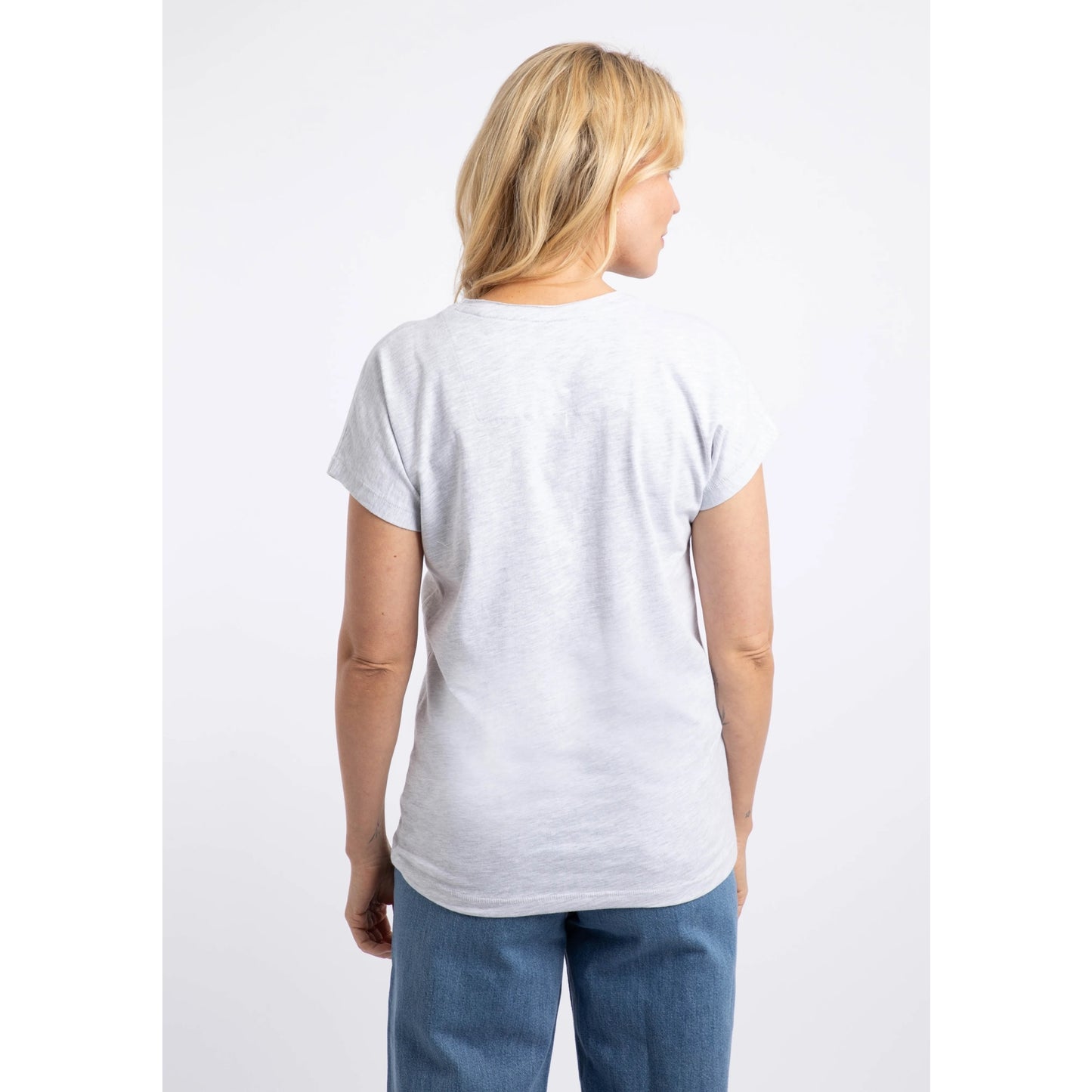 Back view of a woman wearing a Weird Fish short sleeve t-shirt in Light Grey Marl with a Koi Carp print on the front made up of Fern leaves.