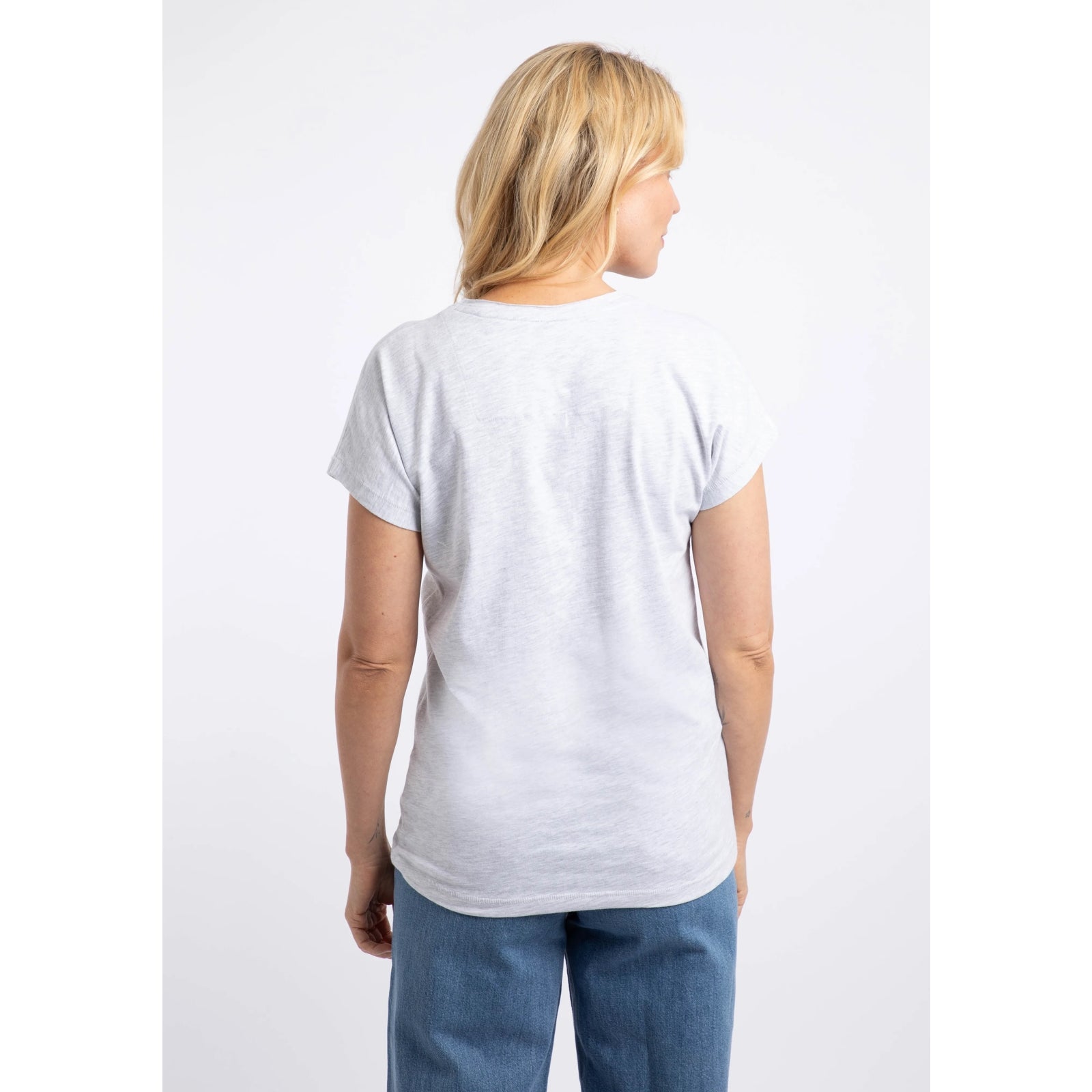 Back view of a woman wearing a Weird Fish short sleeve t-shirt in Light Grey Marl with a Koi Carp print on the front made up of Fern leaves.
