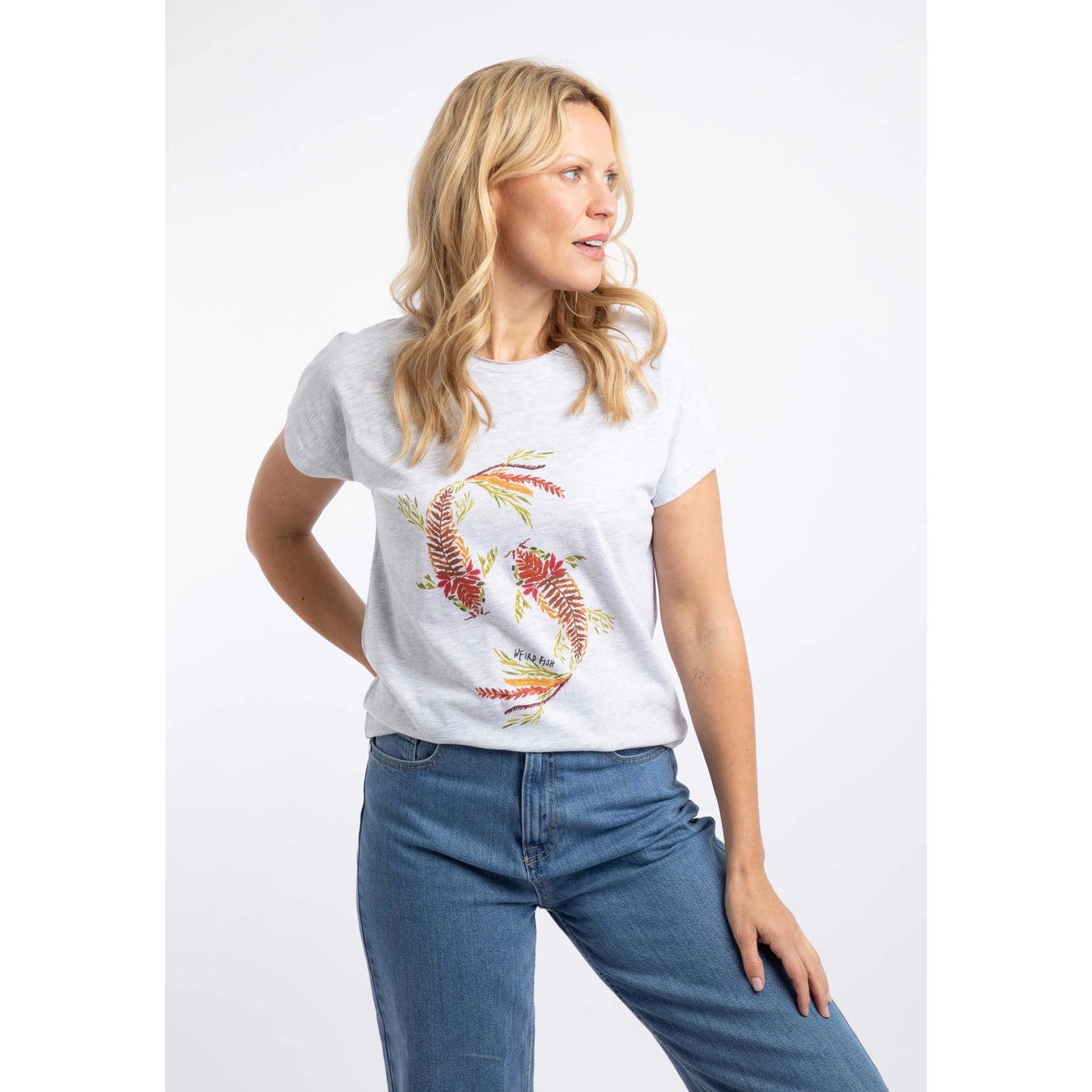 Front view of a woman wearing a Weird Fish short sleeve t-shirt in Light Grey Marl with a Koi Carp print on the front made up of Fern leaves.