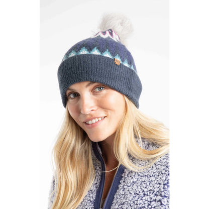 Woman wearing a navy blue Weird Fish knitted Frady beanie with a fleece top on a white background
