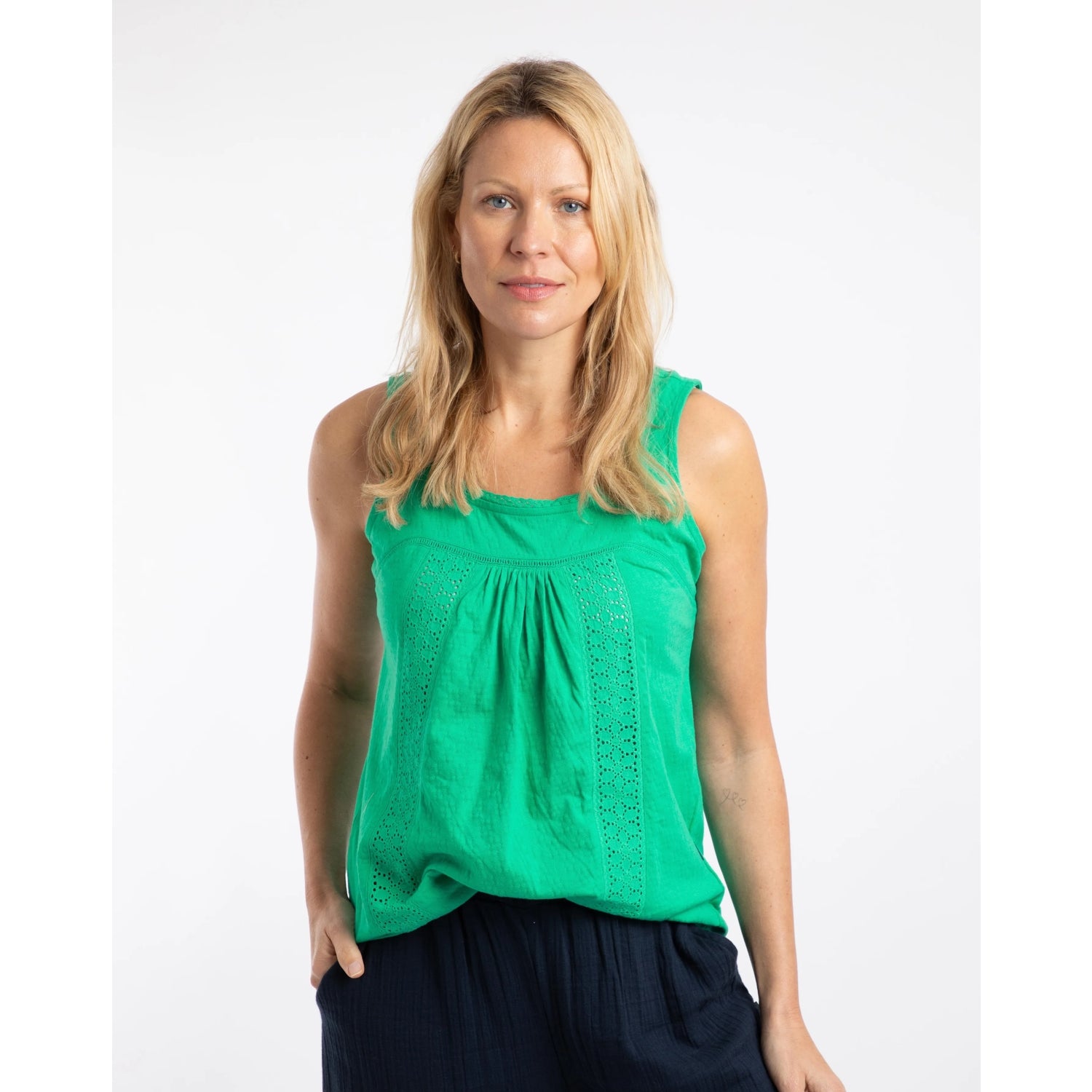 Front view of a woman wearing a Weird Fish Chelle square neck vest in Gumdrop Green with lace front trim