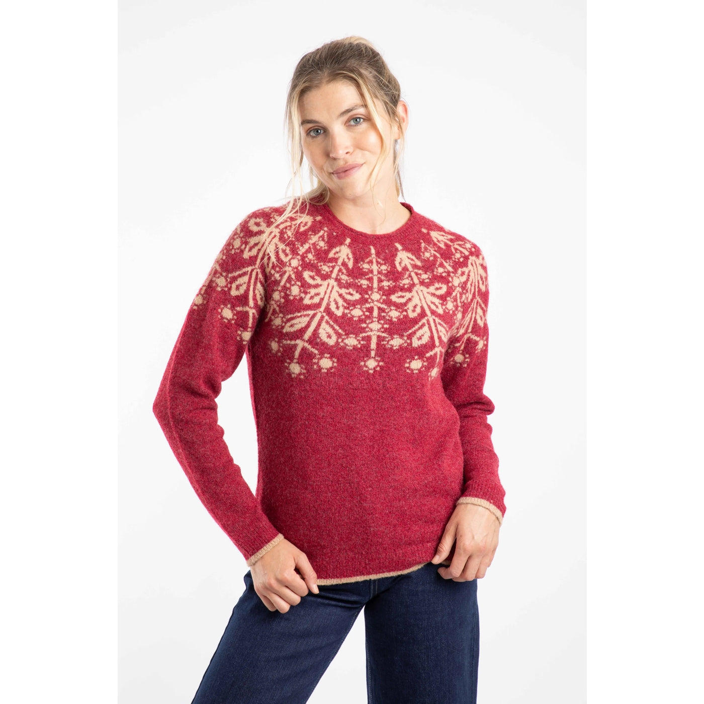 Woman wearing a red Weird Fish Miska knitted jumper with a Fair Isle pattern on a white background
