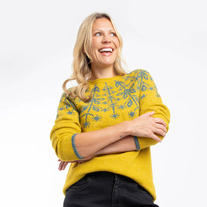 Woman wearing a yellow Weird Fish Miska knitted jumper with a Fair Isle pattern on a white background