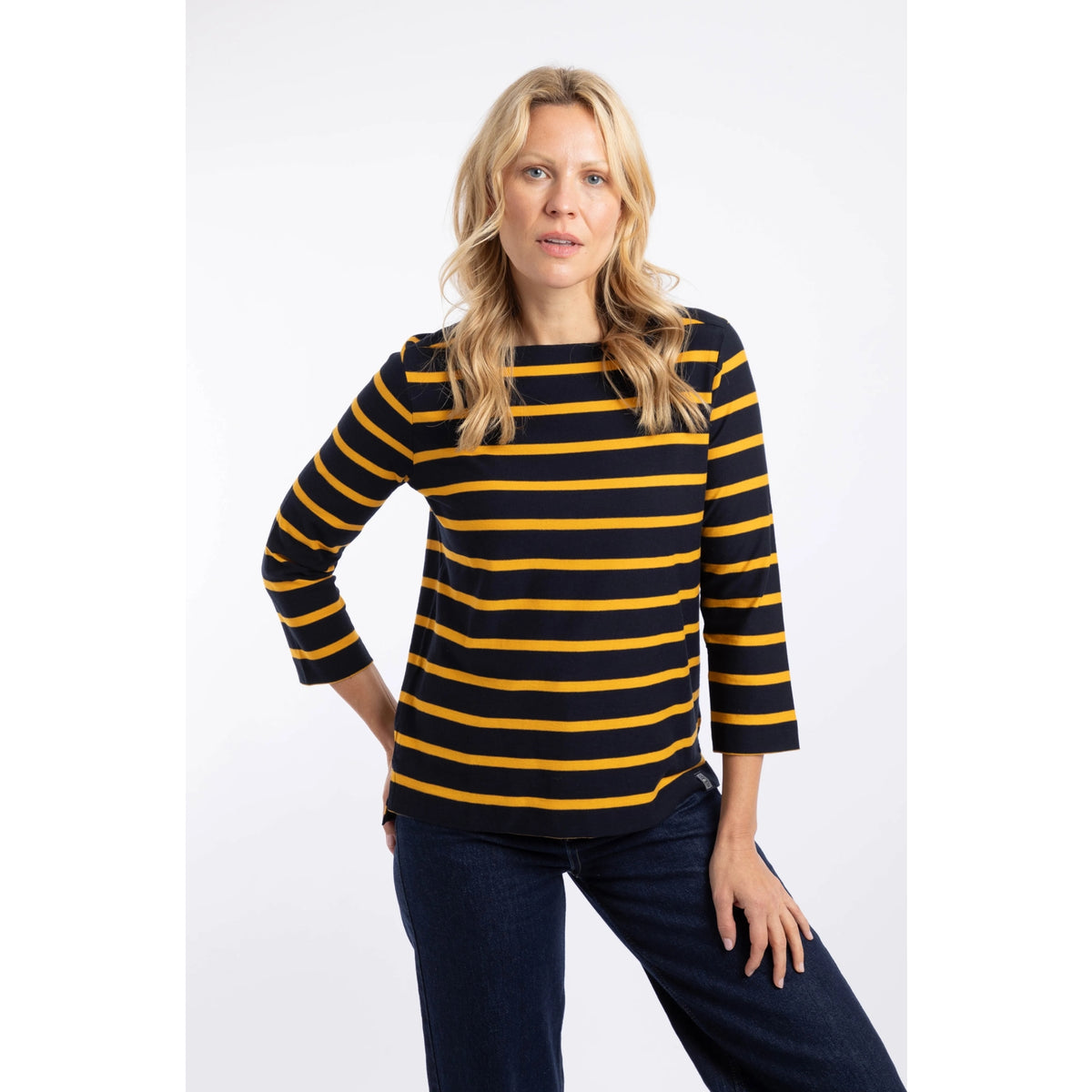 Front view of a woman wearing a Weird Fish Saffira 3/4 length sleeve top in Midnight Navy with Gold Yellow stripes.