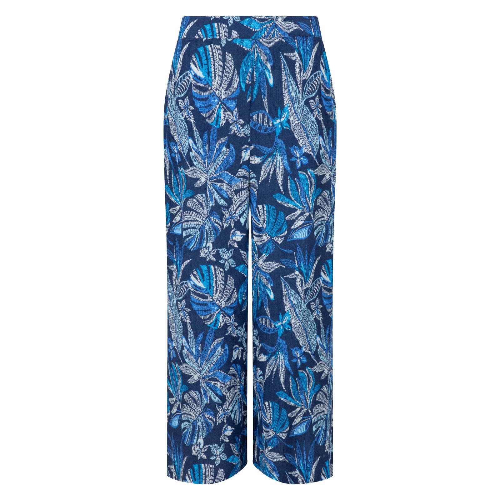 Front view of a pair of Weird Fish Sarita wide leg crinkle viscose cropped trousers in indigo blue with a tropical leaf pattern.