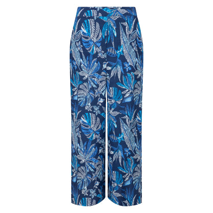 Front view of a pair of Weird Fish Sarita wide leg crinkle viscose cropped trousers in indigo blue with a tropical leaf pattern.