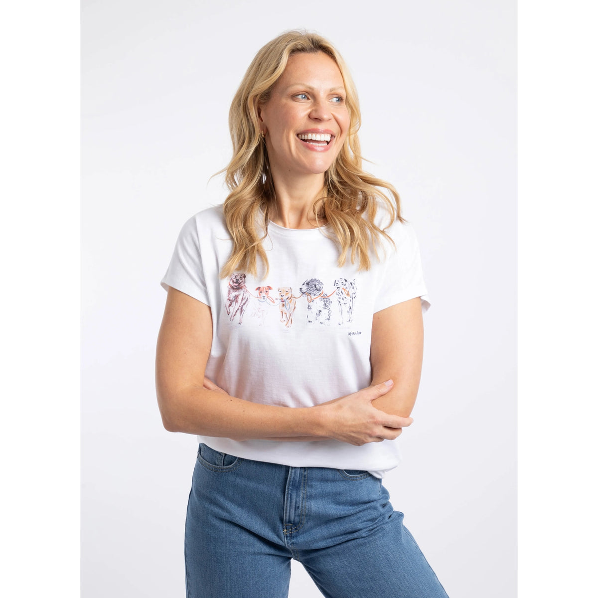 Front view of a woman wearing a Weird Fish short sleeve Take the Lead t-shirt in white with five dogs printed across the chest.