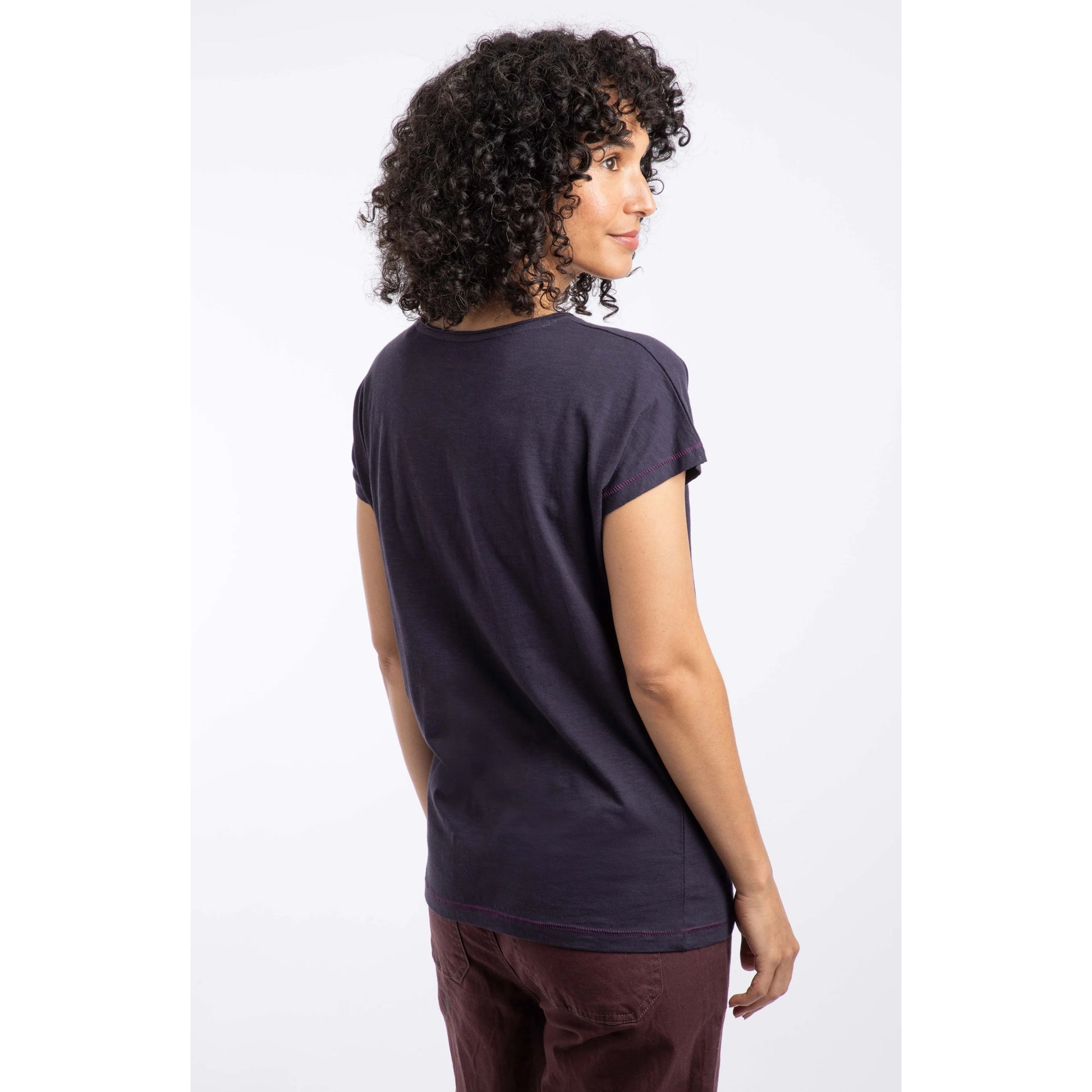 Woman wearing a navy t-shirt on a white background