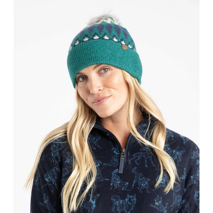 Woman wearing an Ivy Green Weird Fish knitted Frady beanie with a Fair Isle pattern on a white background