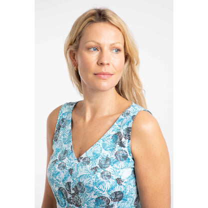 Woman wearing a v-neck sleeveless Weird Fish Indus tunic with a blue shell pattern against a white background