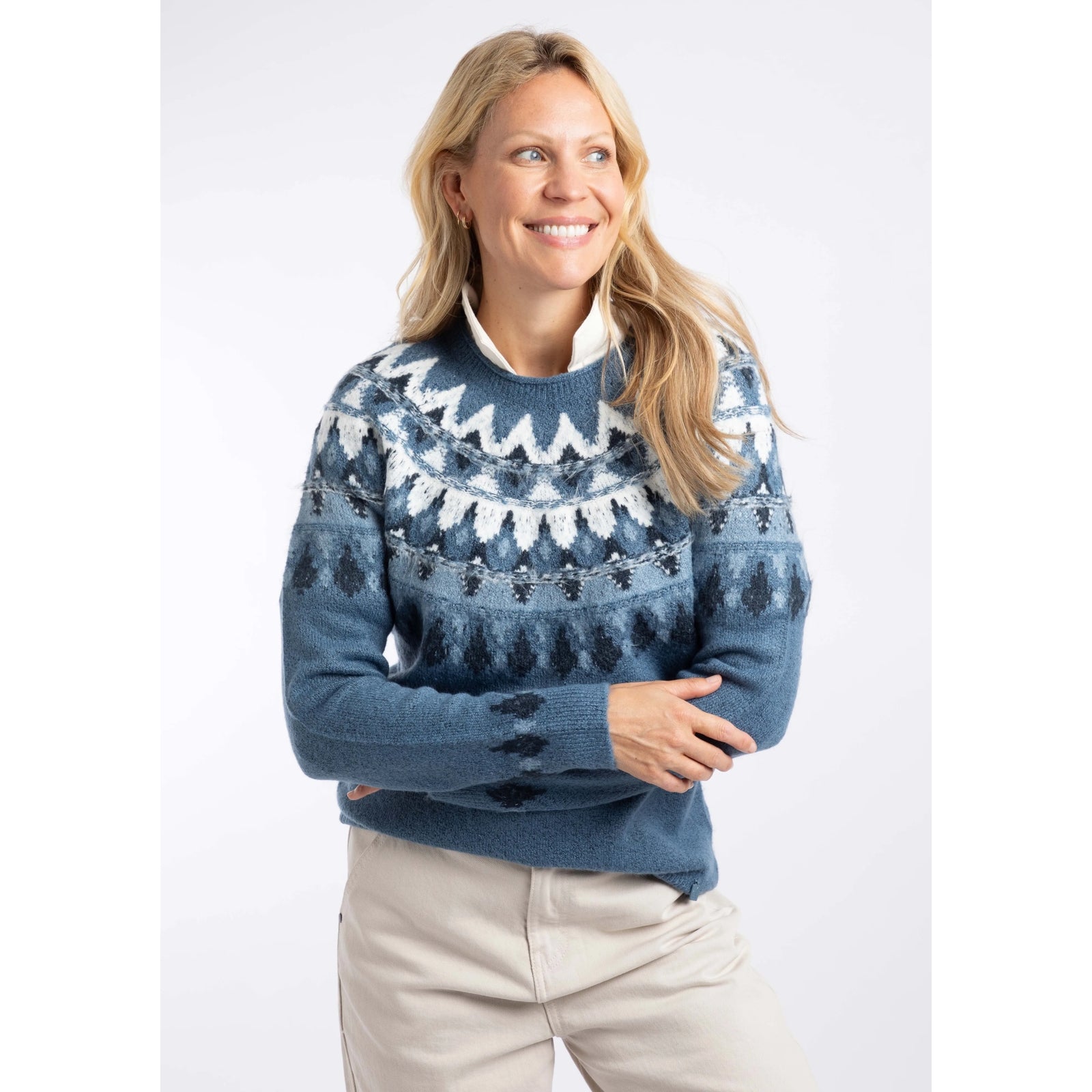 Front view of a woman wearing a Weird Fish knitted Lowell jumper in Ash Blue, with a Fair Isle pattern across the chest and shoulders.