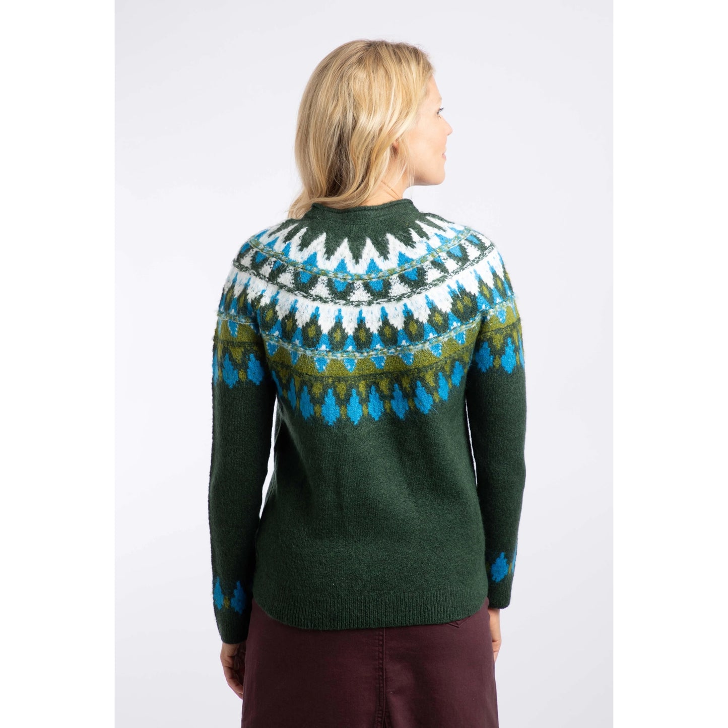 Back view of a woman wearing a Weird Fish knitted Lowell jumper in Bottle Green, with a Fair Isle pattern across the chest and shoulders.