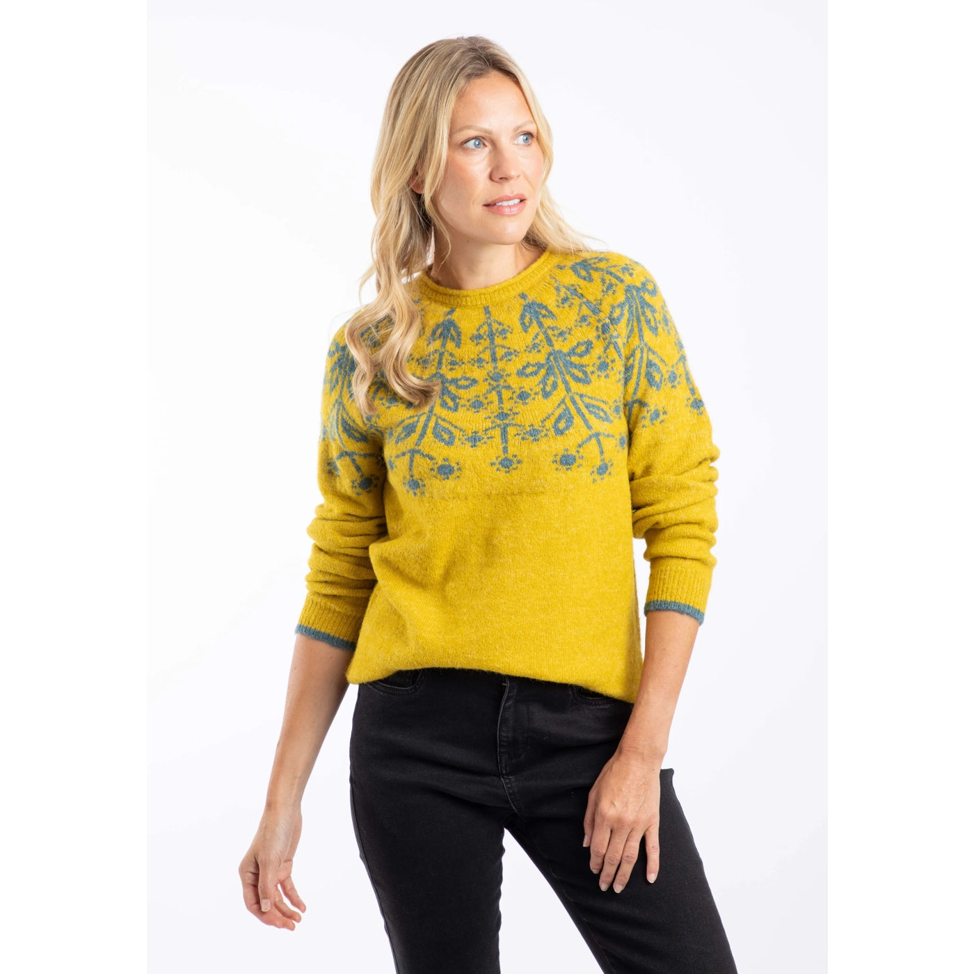 Front view of a woman wearing a yellow Weird Fish Miska knitted jumper with a beige Fair Isle pattern and beige trousers.