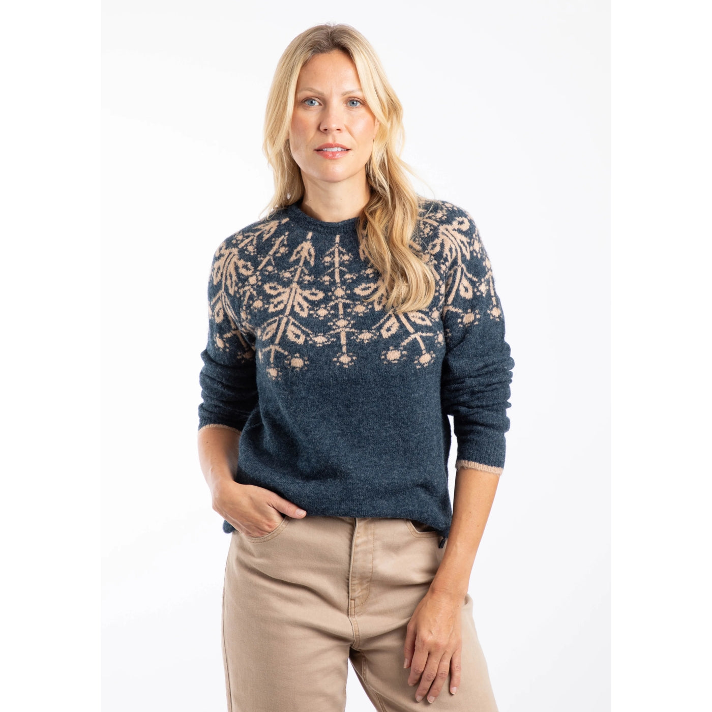Woman wearing a navy blue Weird Fish Miska knitted jumper with a Fair Isle pattern on a white background