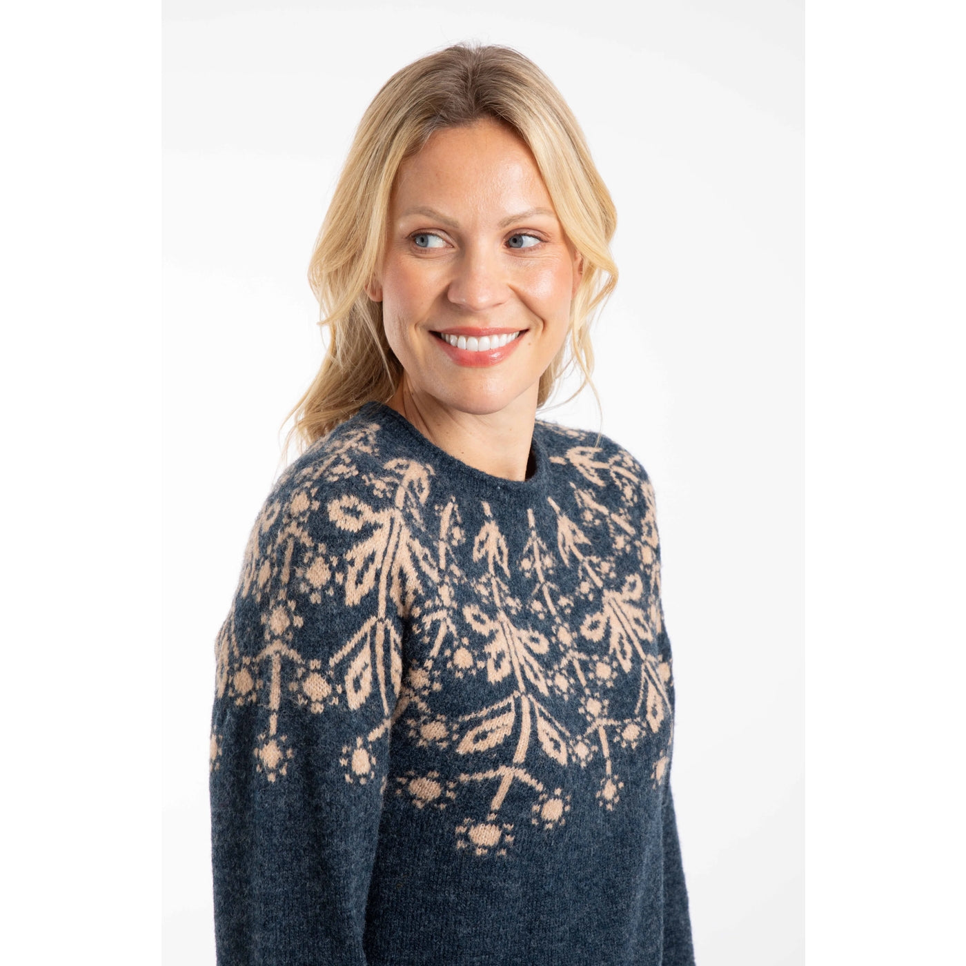 Woman wearing a Weird Fish navy Miska jumper with a beige Fair Isle pattern across the chest and shoulders.