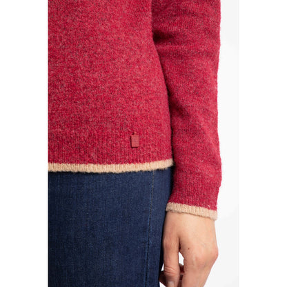Close-up of a woman wearing a red Weird Fish Miska jumper with beige trim on a white background