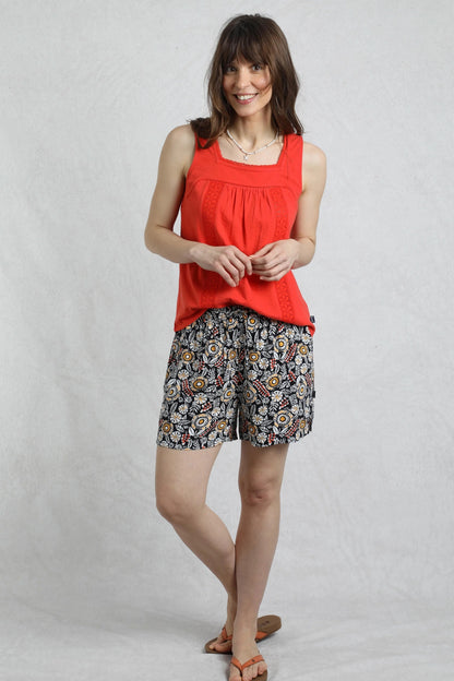 Weird Fish womens navy floral shorts worn by model with red sleeveless top and sandals