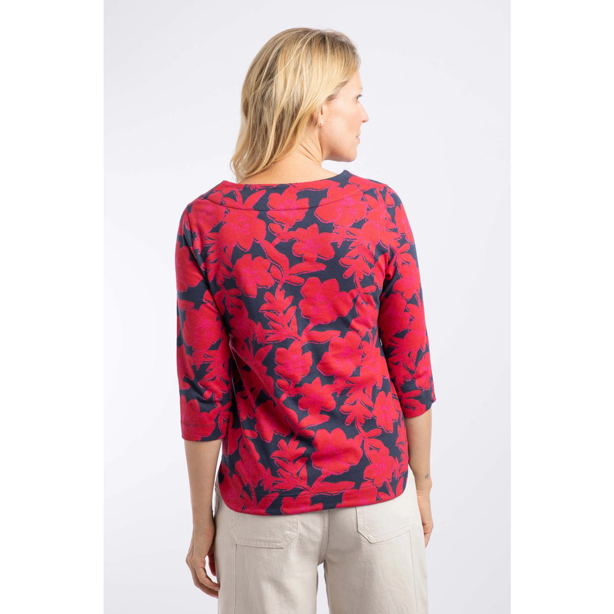 Back view of a woman wearing a Weird Fish three-quarter sleeve Pinto t-shirt in Cranberry Red with a bold floral pattern.