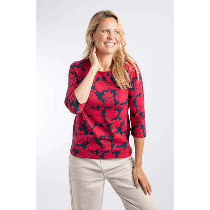 Front view of a woman wearing a Weird Fish three-quarter sleeve Pinto t-shirt in Cranberry Red with a bold floral pattern.