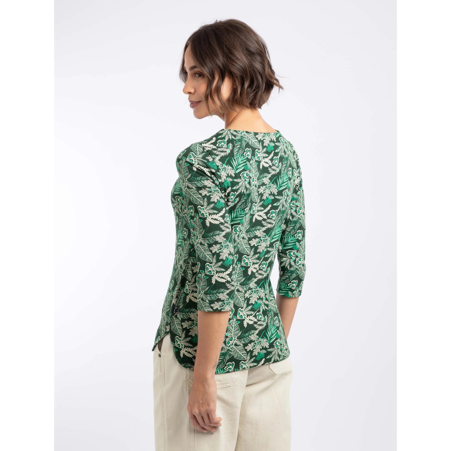 Back view of a woman wearing a Weird Fish three-quarter sleeve Pinto t-shirt in Laurel Green with a leafy floral pattern.