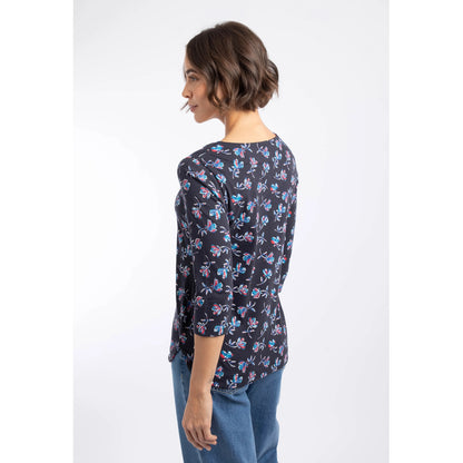 Back view of a woman wearing a Weird Fish three-quarter sleeve Pinto t-shirt in Midnight Navy with a blue and red floral pattern.