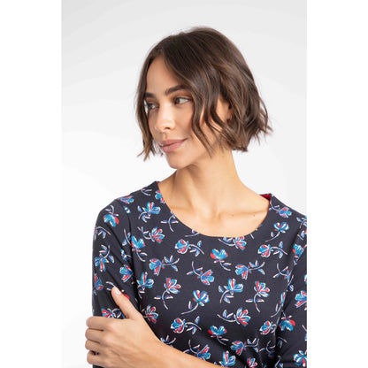 Close-up view of a woman wearing a Weird Fish three-quarter sleeve Pinto t-shirt in Midnight Navy with a blue and red floral pattern.