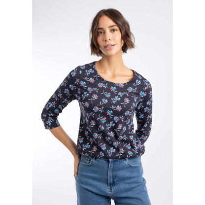 Front view of a woman wearing a Weird Fish three-quarter sleeve Pinto t-shirt in Midnight Navy with a blue and red floral pattern.