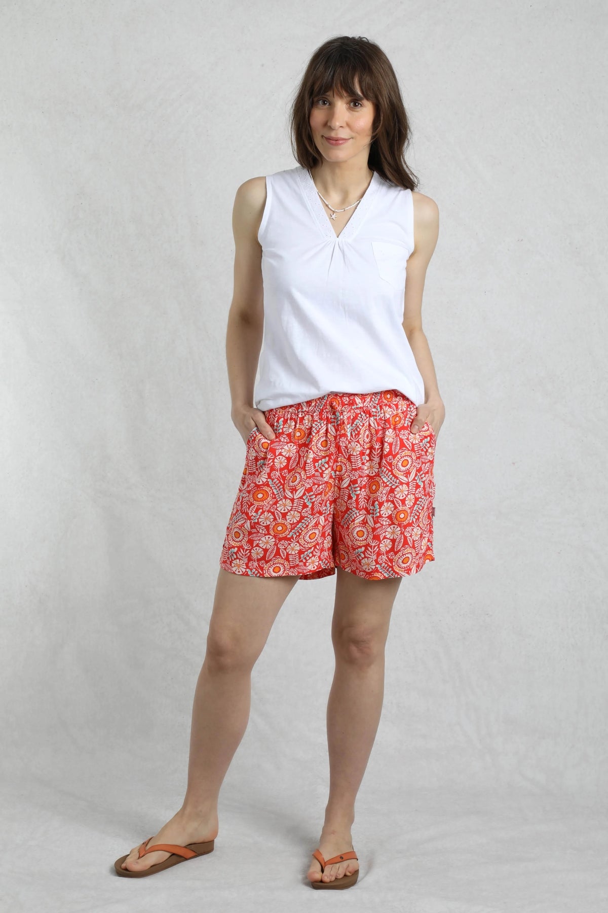 Weird Fish womens red floral shorts with elastic waist and pockets modeled with white sleeveless top