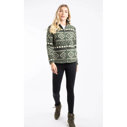 A woman wearing a Weird Fish full zip Rochelle fleece in Deep Lichen Green with an Aztec pattern with black leggings and boots.