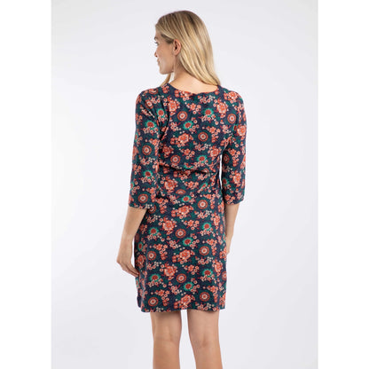Woman wearing a Weird Fish blue and coral 3/4 sleeve Starshine floral dress on a white background