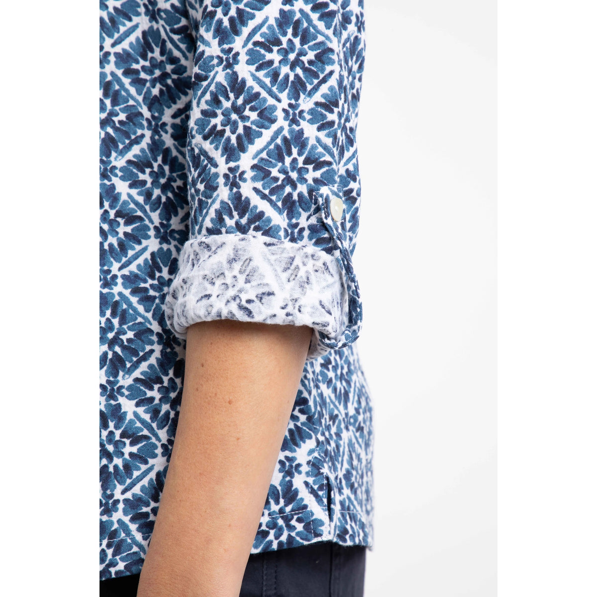 Close-up of a womens Weird Fish blue and white patterned Syona  shirt with rolled-up sleeves on a white background