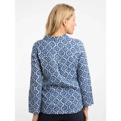 Back view of a woman wearing a Weird Fish Syona blue tile print patterned shirt on a white background