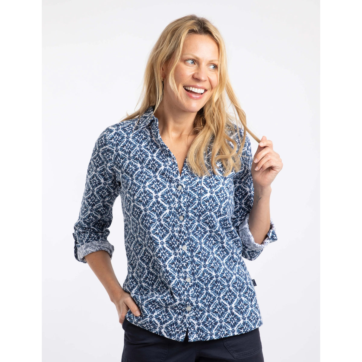 Front view of a woman wearing a Weird Fish Syona shirt in a Twilight blue tile print on a white background