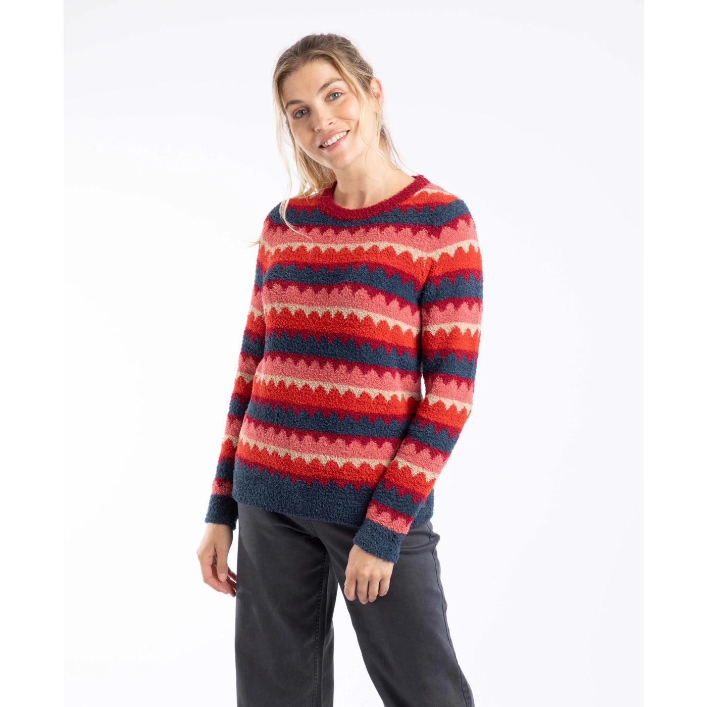 Woman wearing a Weird Fish Tyla jumper in Antique Cherry Red and blue stripe on a white background