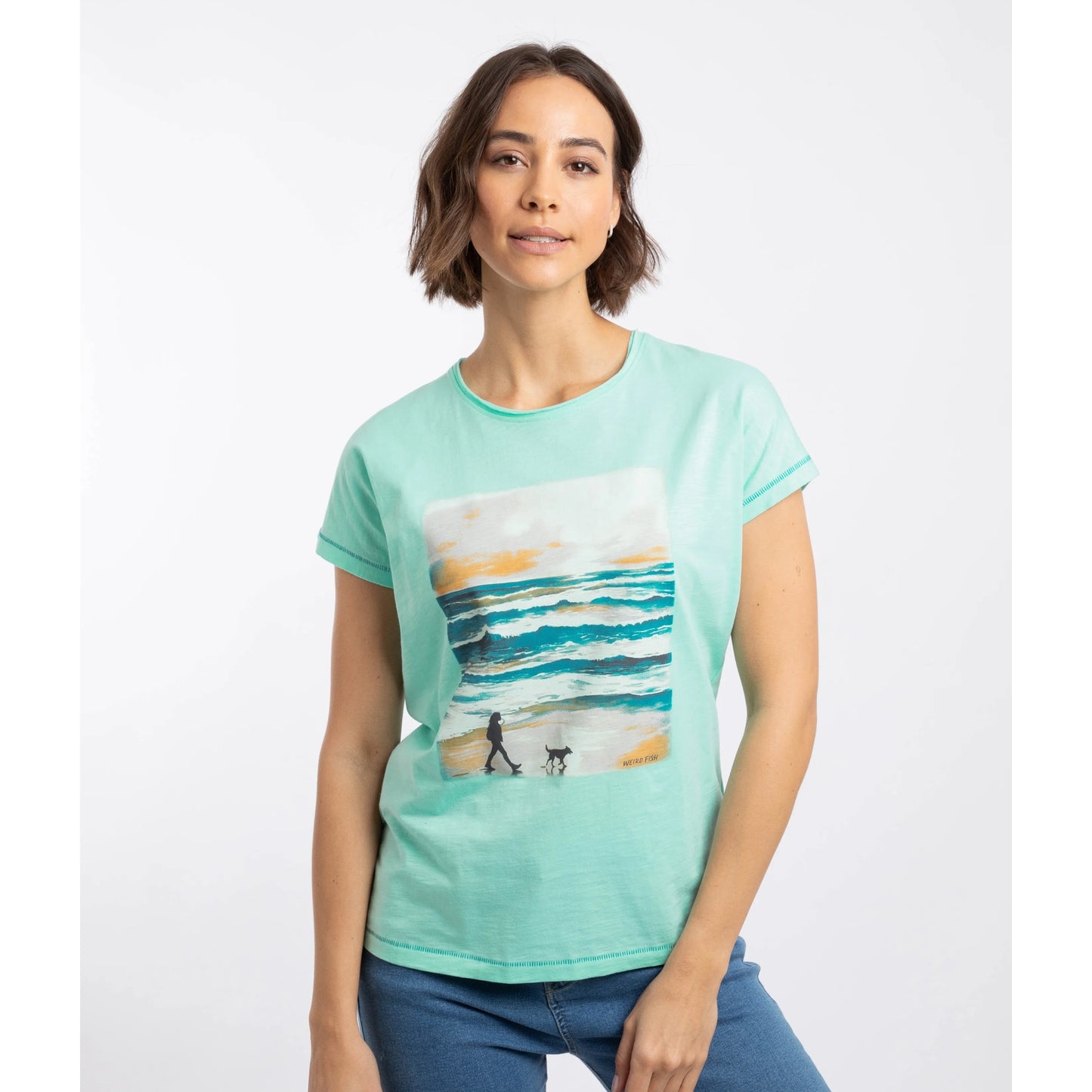 Front view of a woman wearing a Weird Fish short sleeve Walking Club dog walking print t-shirt in Apple Mint on a white background