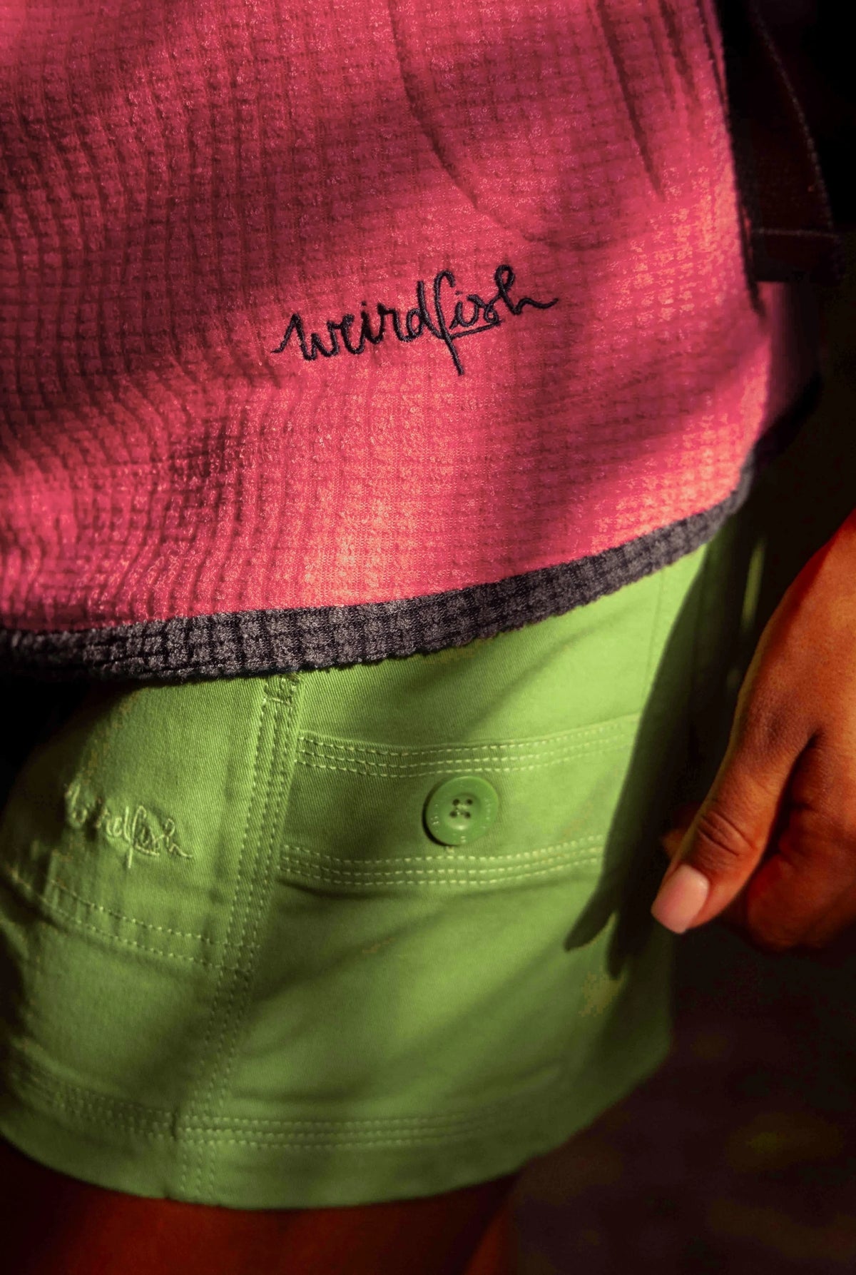 Women's Willoughby shorts from Weird Fish in Kiwi Green with button side pockets.