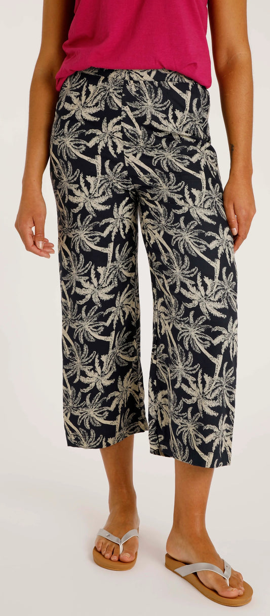 Weird Fish women's Tresco crop trousers in Midnight Navy with a palm tree pattern.