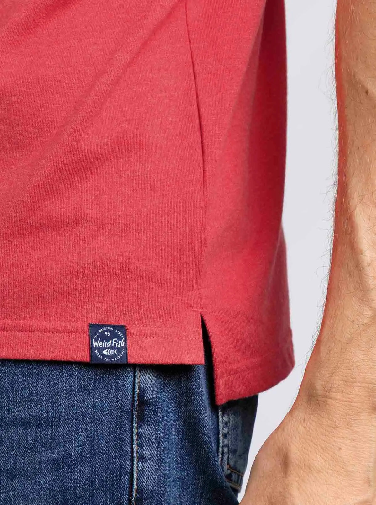 Radical Red coloured men's Jetstream polo shirt from Weird Fish with hem logo label.