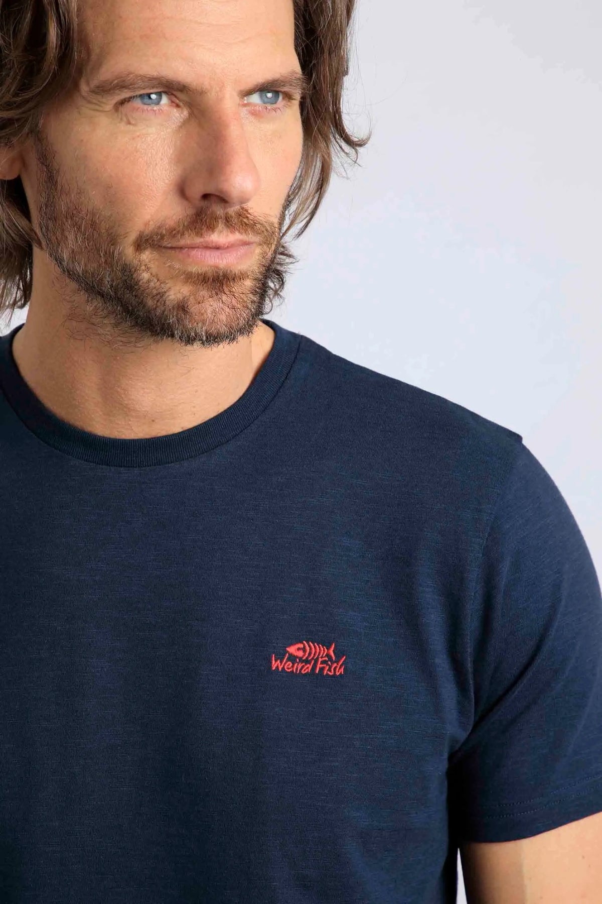 Plain men's tee from Weird Fish in Navy except for a small red logo on the chest.
