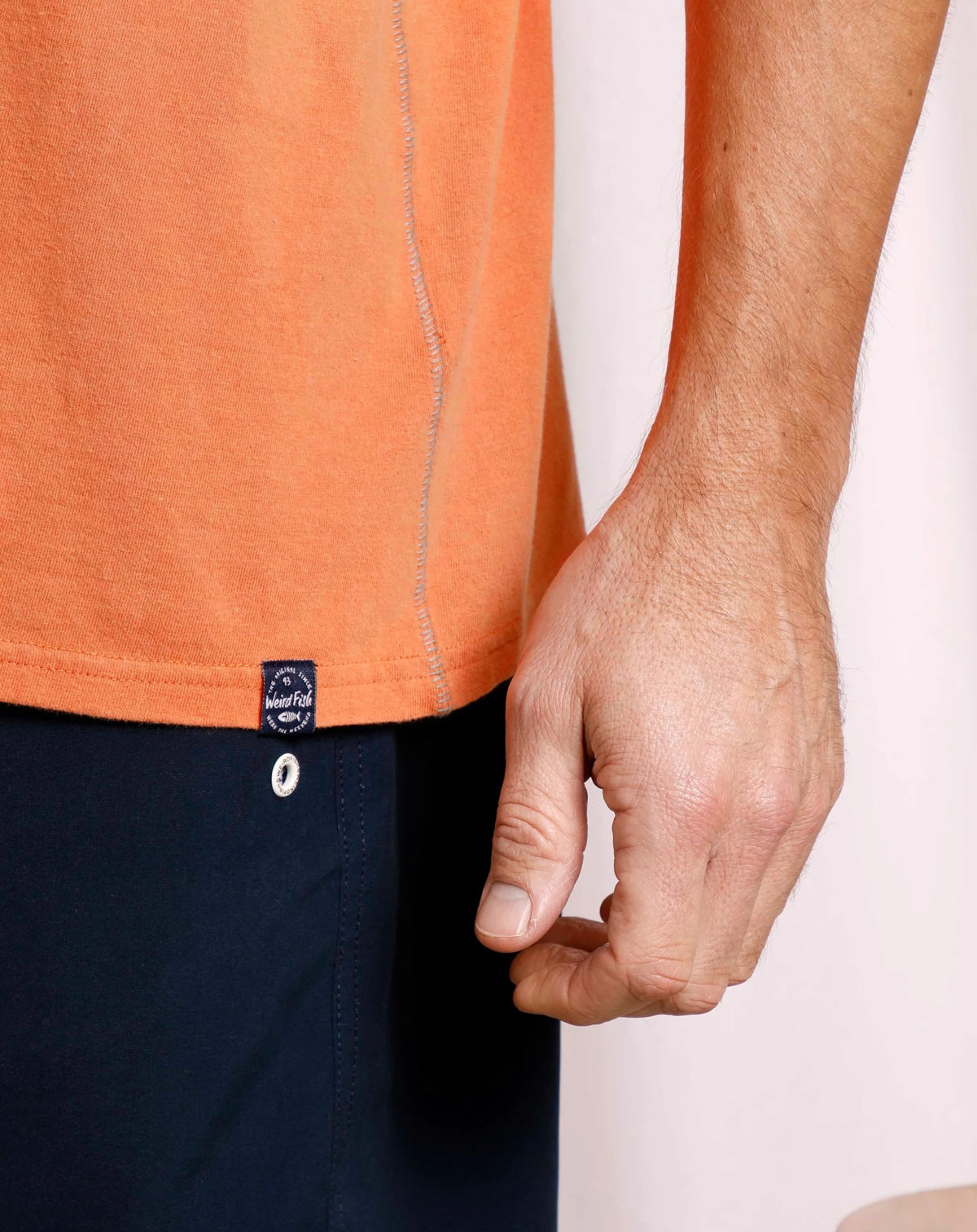 Men's Mango Orange coloured tee from Weird Fish with Original Surf logo print design and small logo label on the bottom hem.