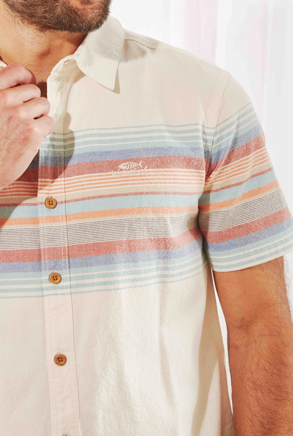 Weird Fish men's Bowfell short sleeve shirt with chest stripe pattern and wood effect buttons.