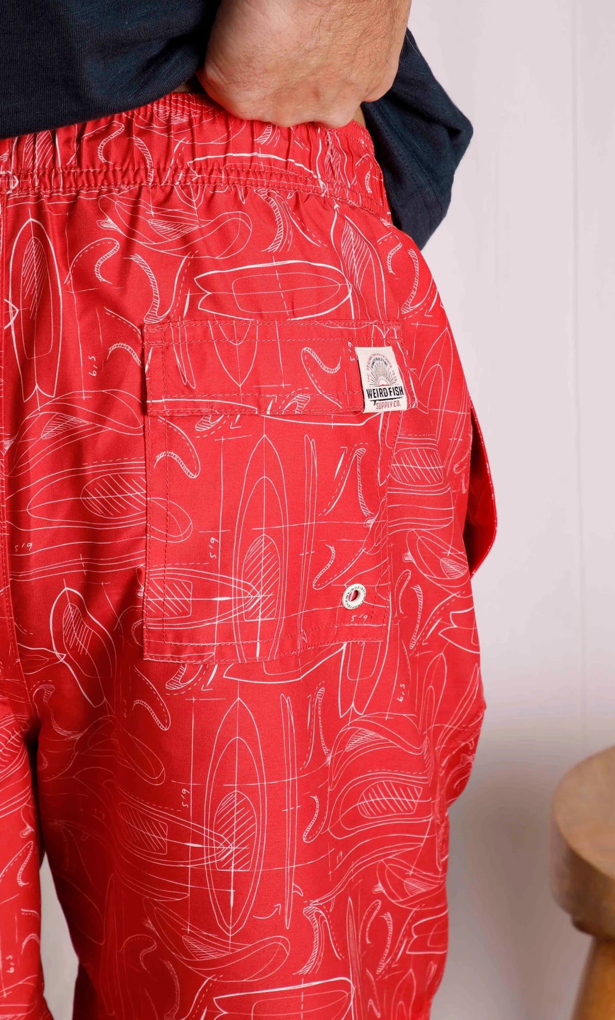Men's Belukha Weird Fish swim shorts in Radical Red with Velcro back pocket.