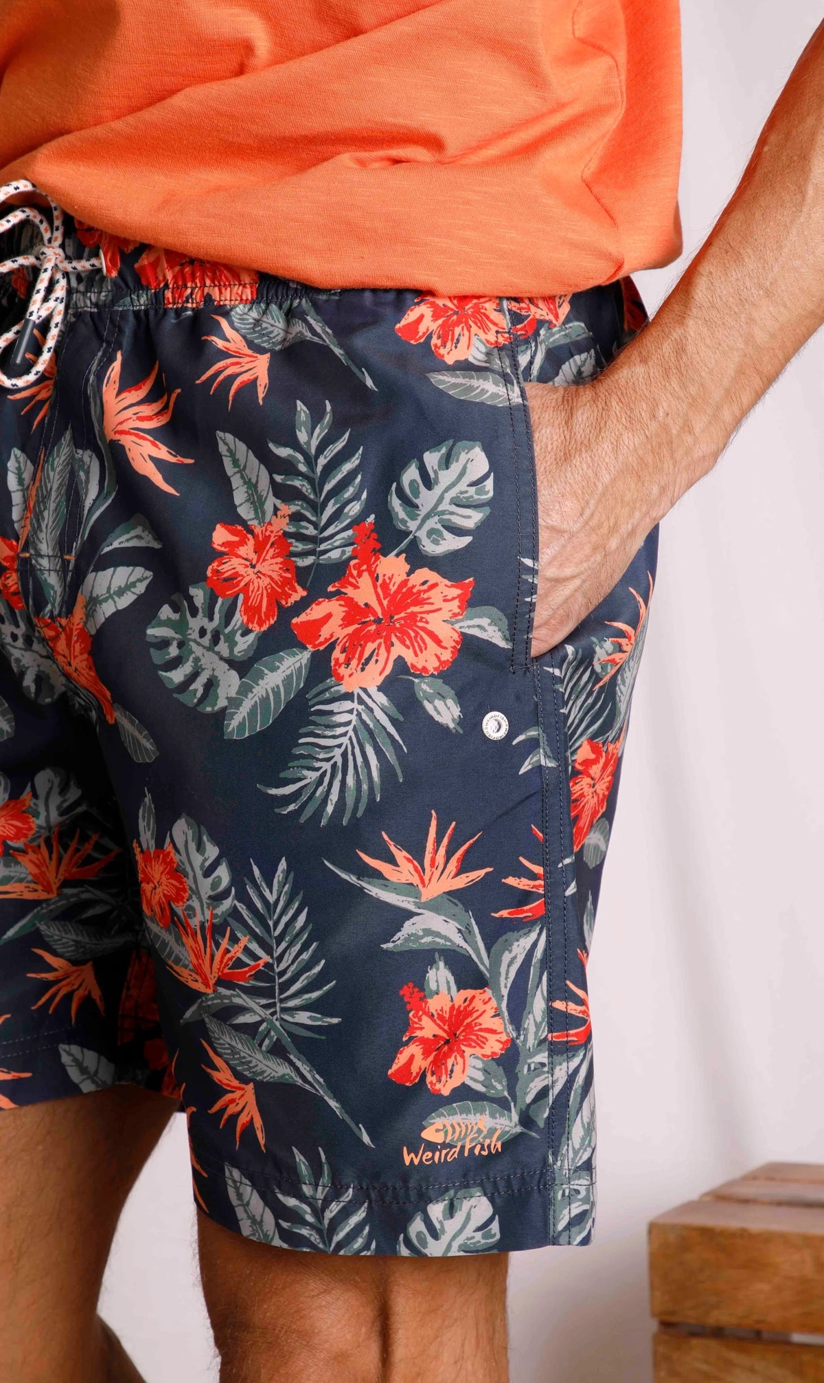 Weird Fish men's Belukha Navy swim shorts with tropical floral print and hip pockets.